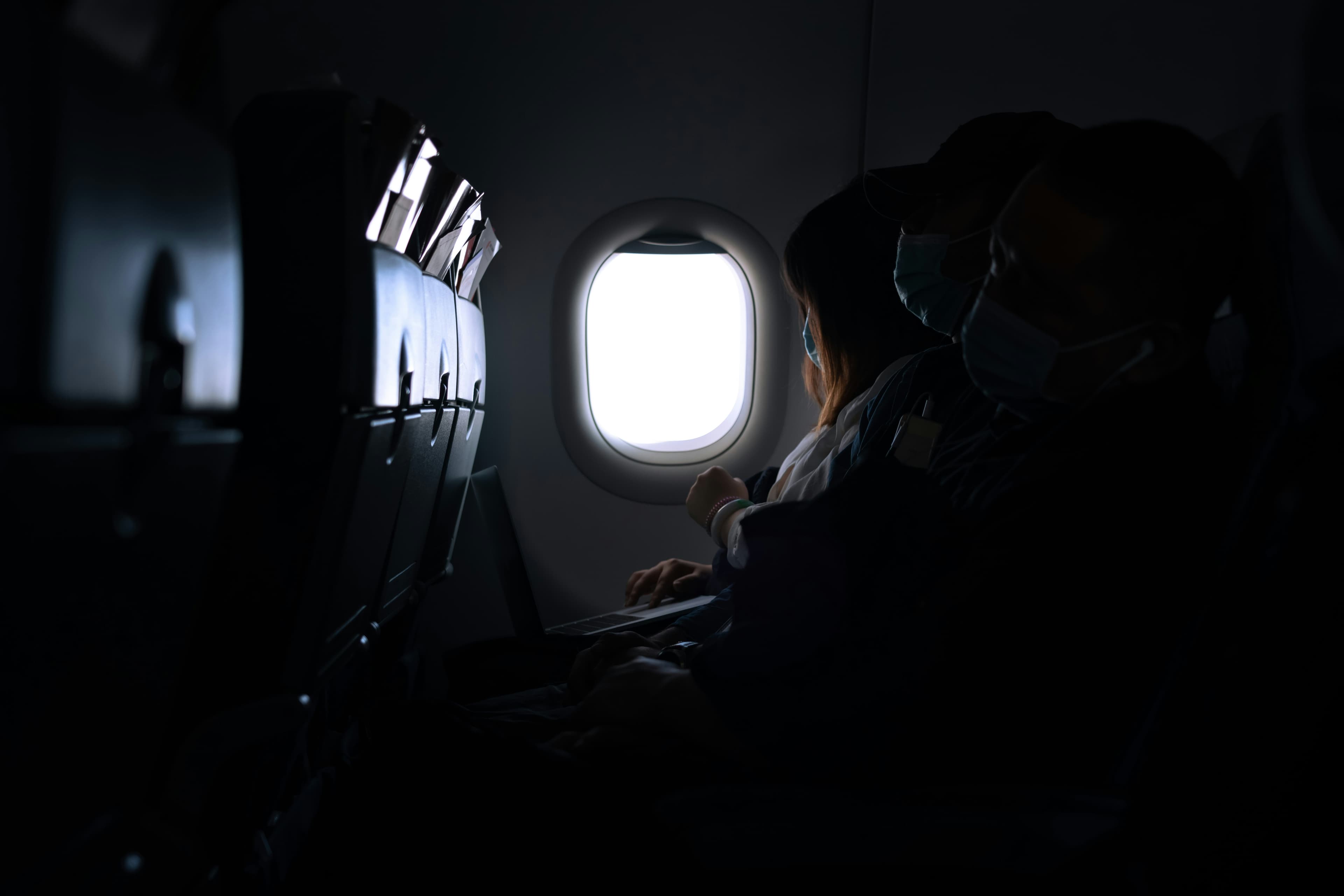 A single empty seat beside an airplane window
